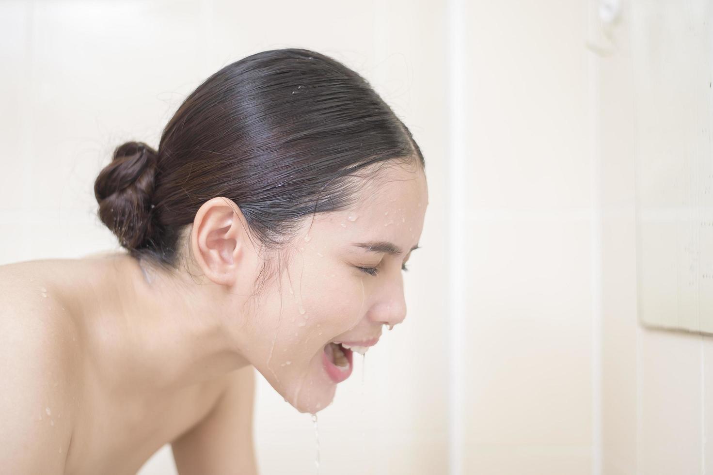 A beautiful woman is washing her face photo