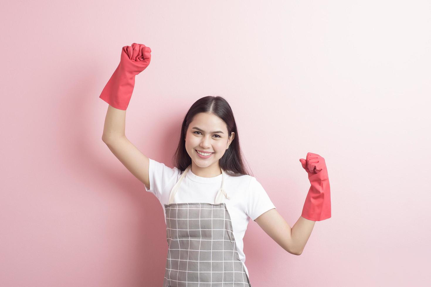 Beautiful woman housekeeper portrait on pink background photo