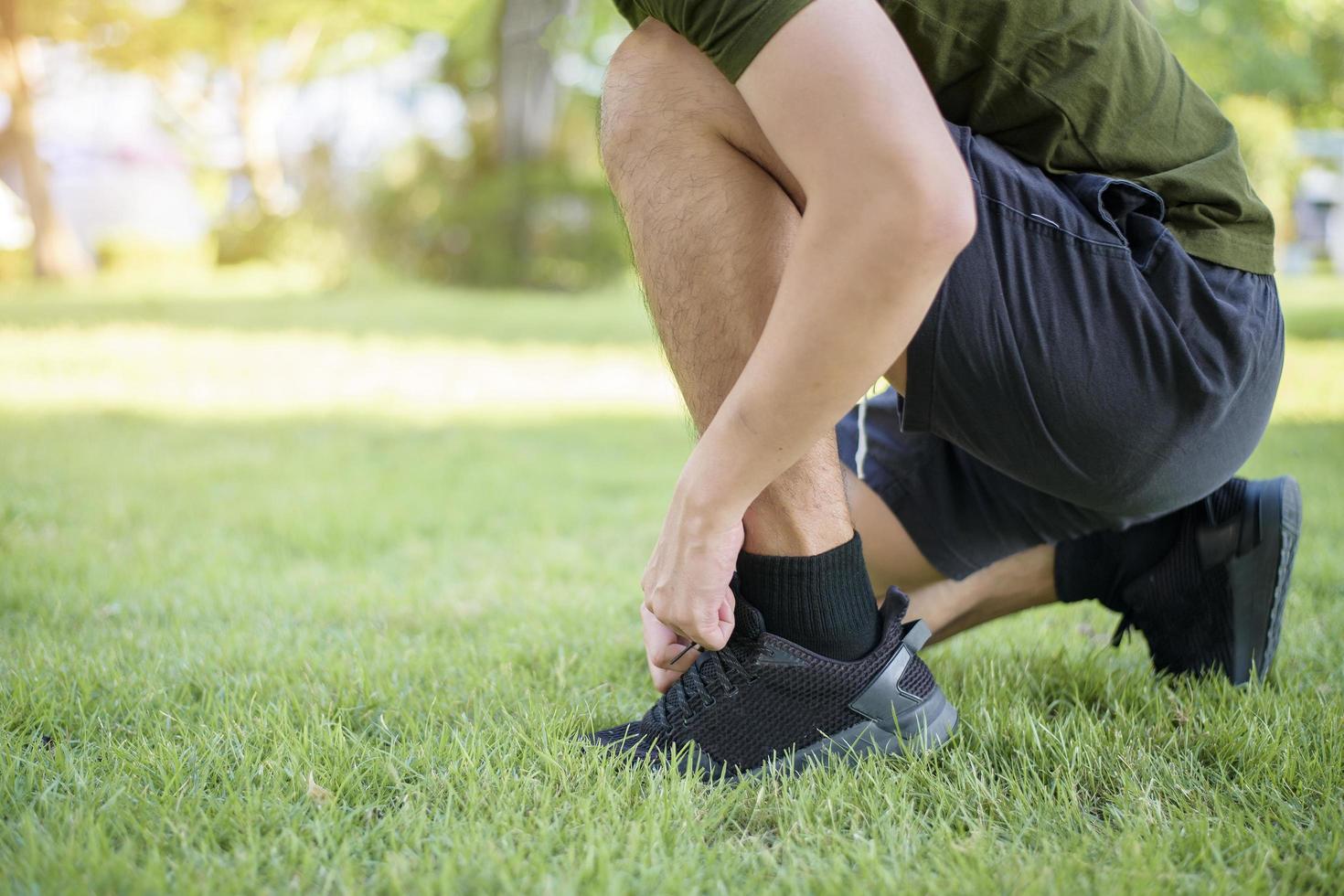 close up of man foot , tying the shoes in outside photo