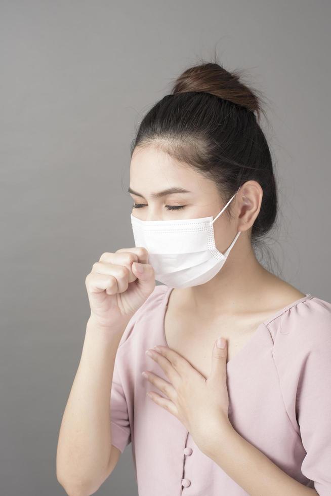 close up woman face is wearing surgical mask photo