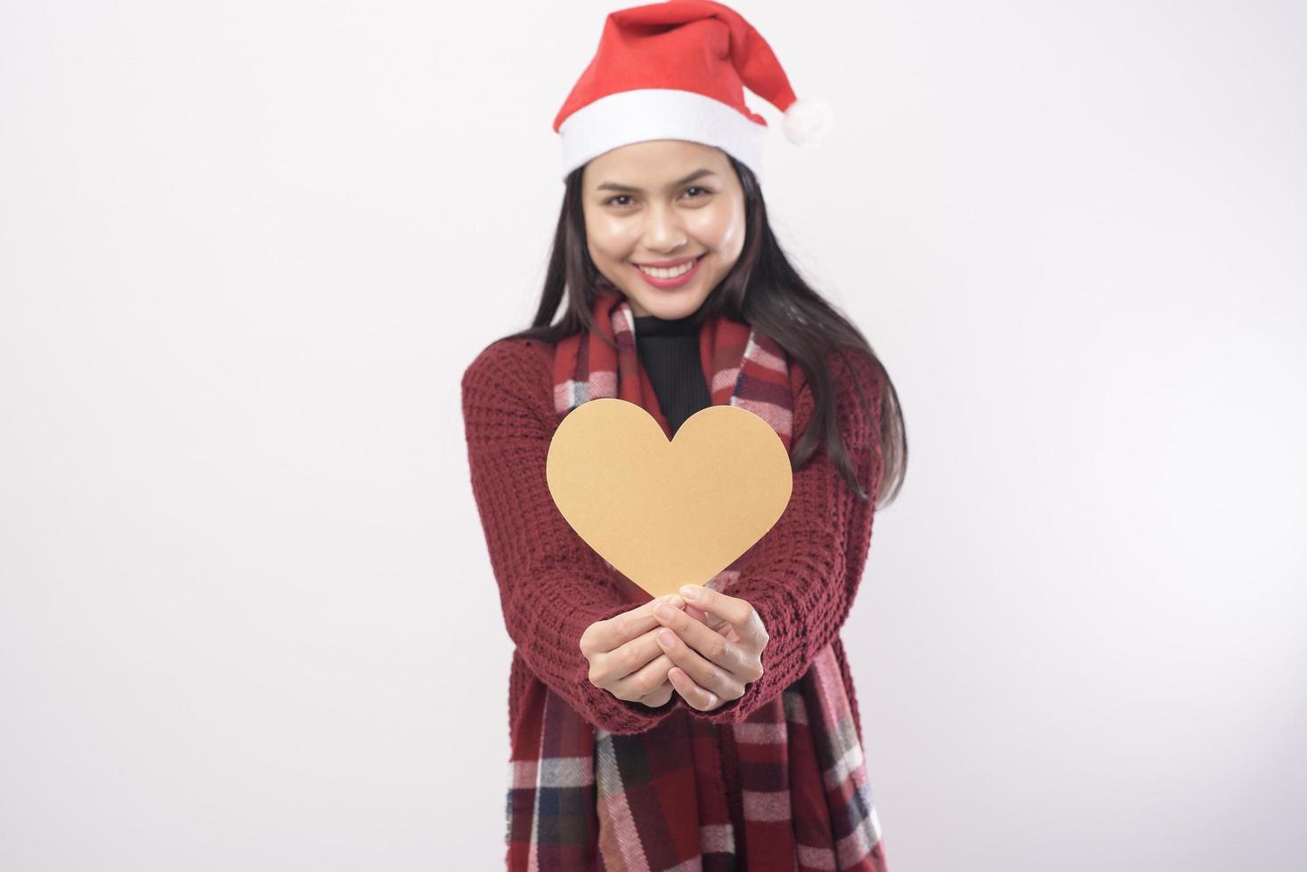 Portrait of young smiling woman wearing red Santa Claus hat isolated white background studio. photo