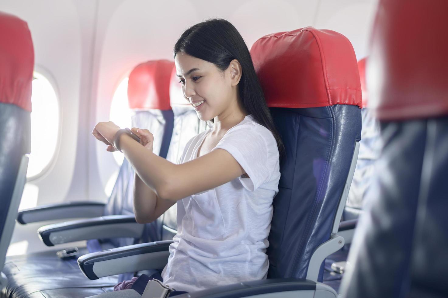 Traveling woman using onboard, technology travel concept photo