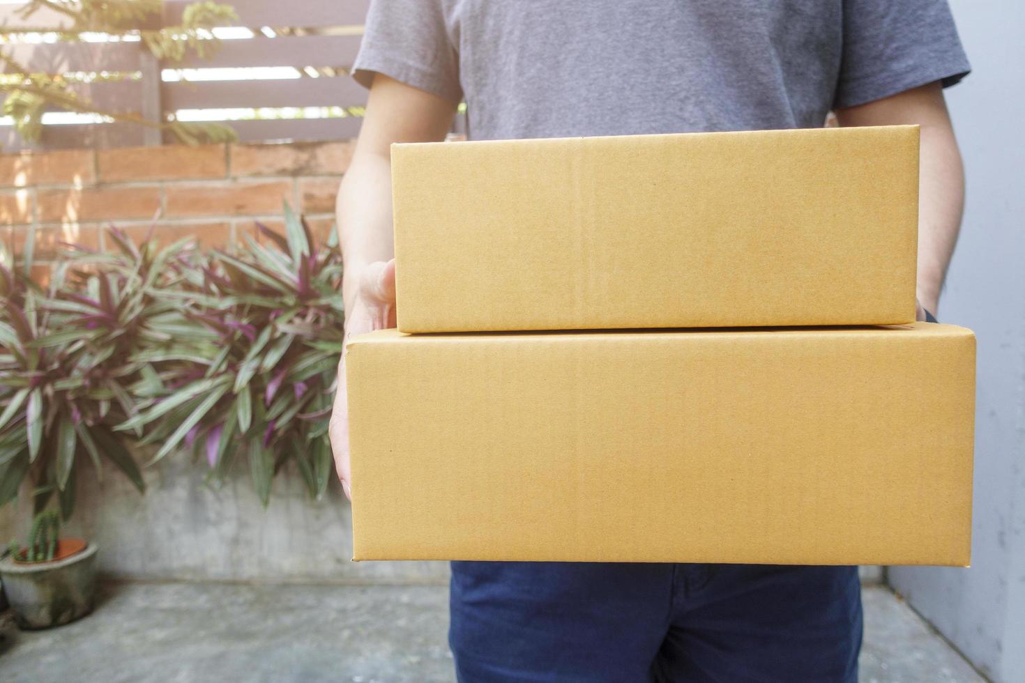 Close up man is holding delivery box at home photo