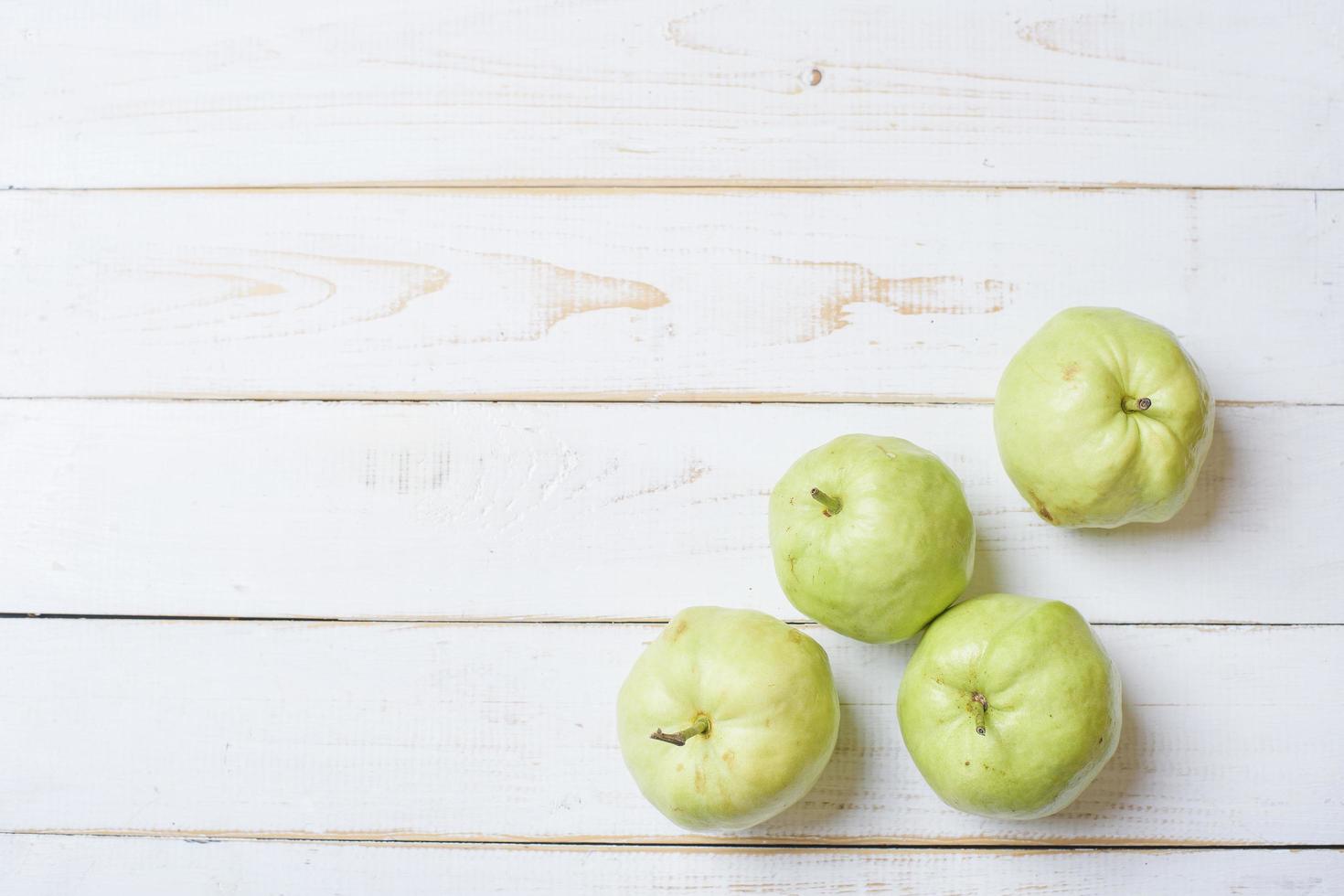 Guavas on white wooden table. photo