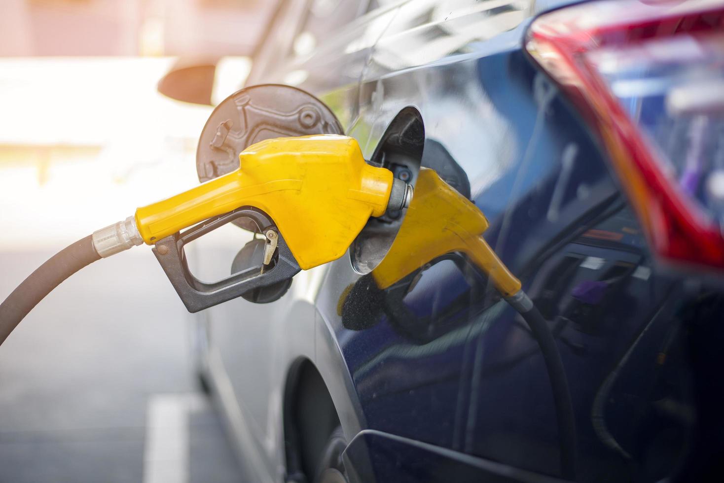 Close up of car is refilling oil fuel in Gas Station photo