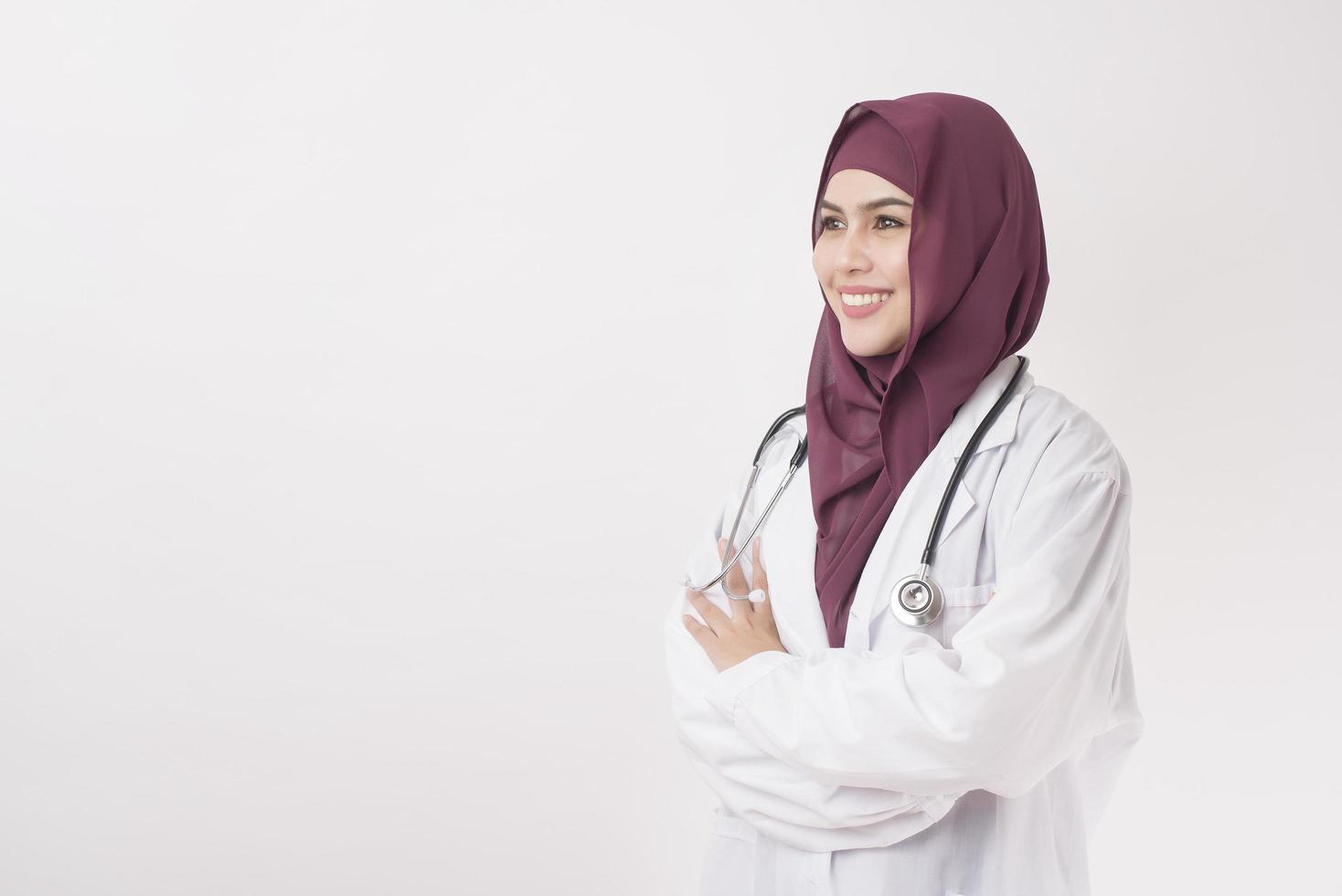 Beautiful woman doctor with hijab portrait on white background photo