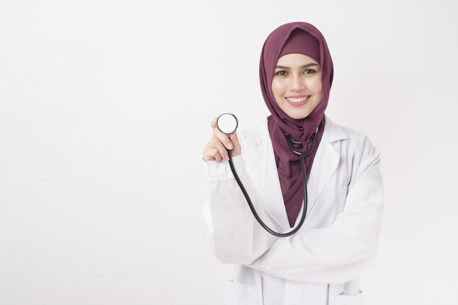 Beautiful woman doctor with hijab portrait on white background photo