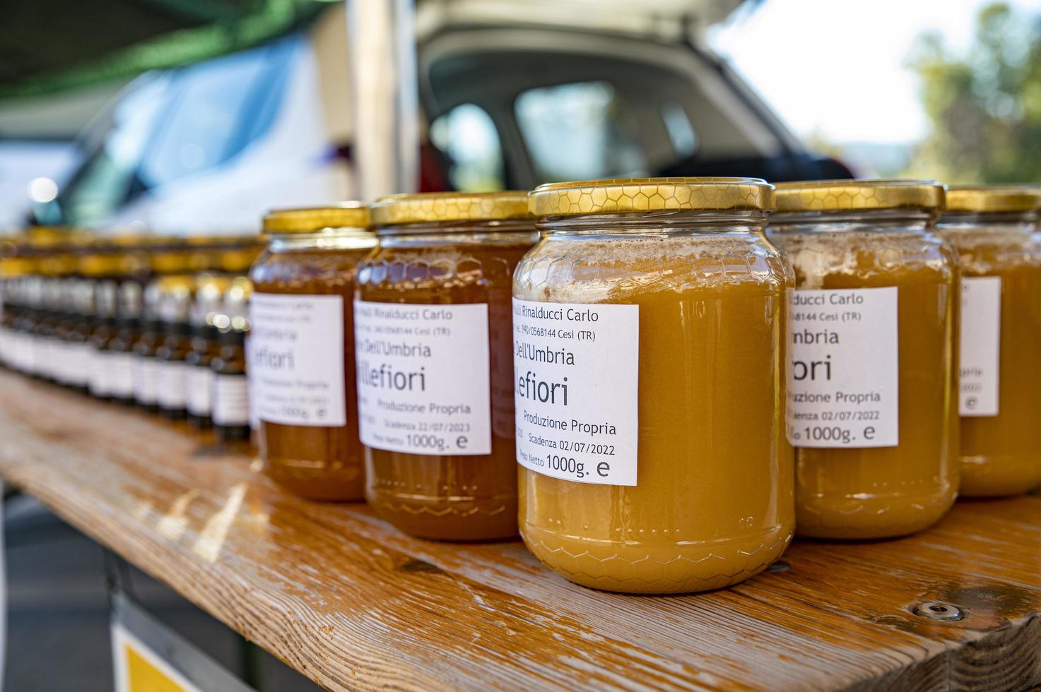 jars of honey for sale at a stall photo