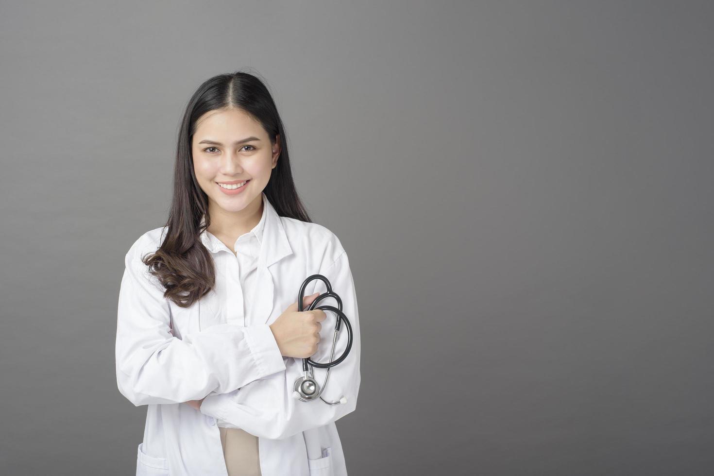 Smart woman doctor is holding stethoscope photo