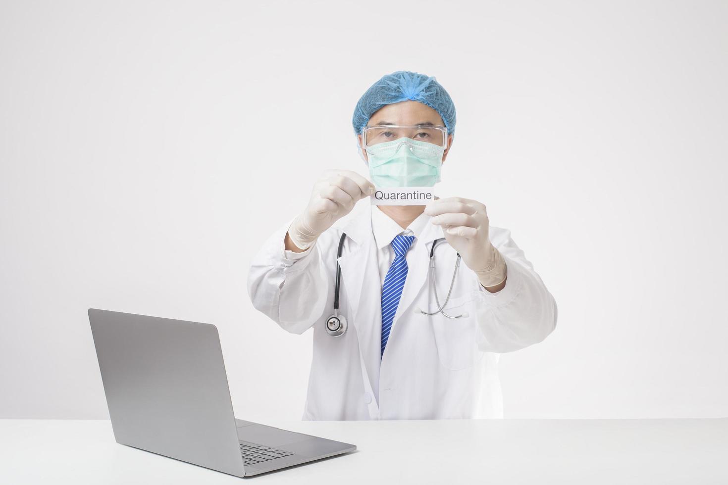 Doctor is holding quanrantine card on white background photo