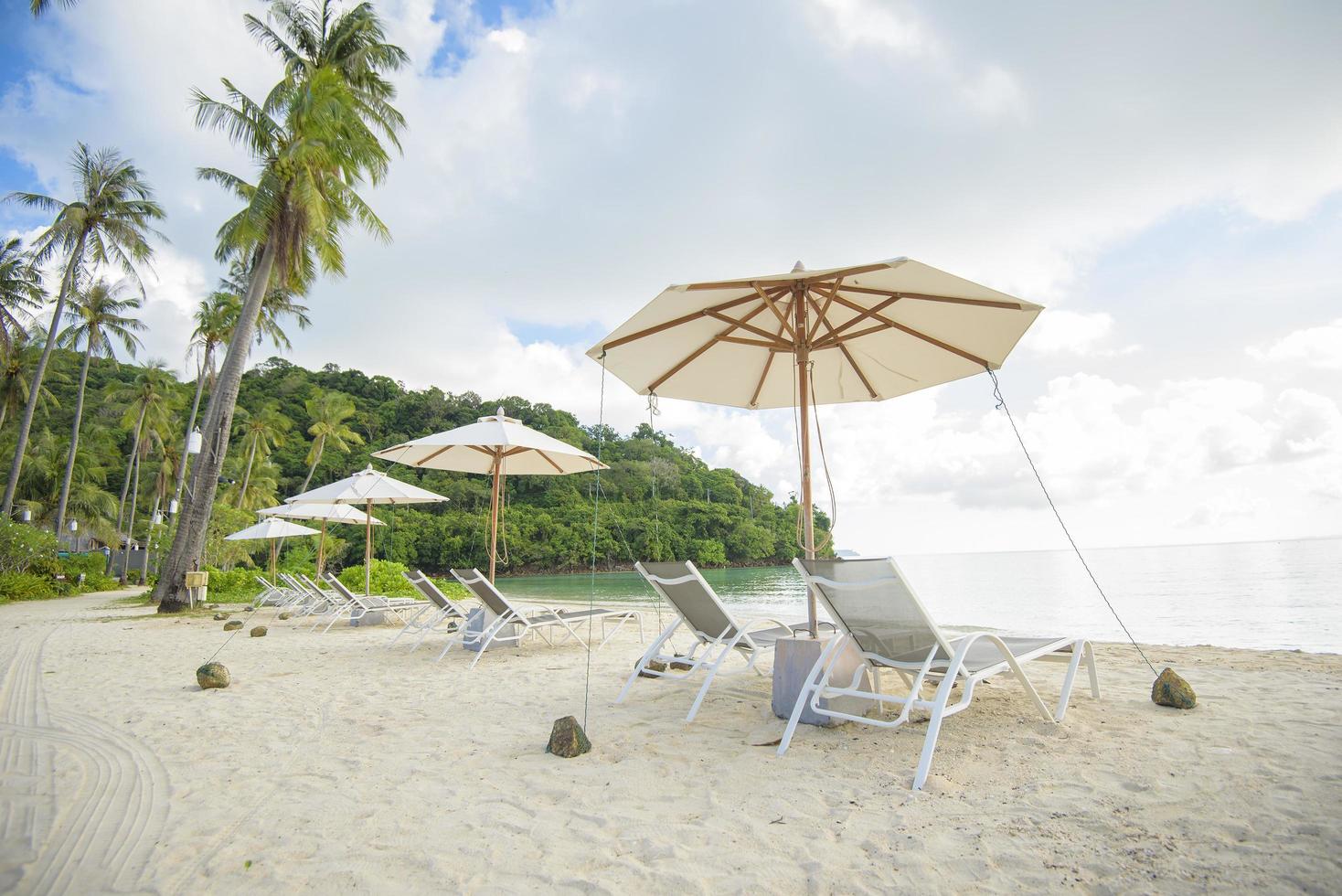 Beautiful view landscape of lounge chairs on tropical beach, the emerald sea and white sand against blue sky, Maya bay in phi phi island , Thailand photo