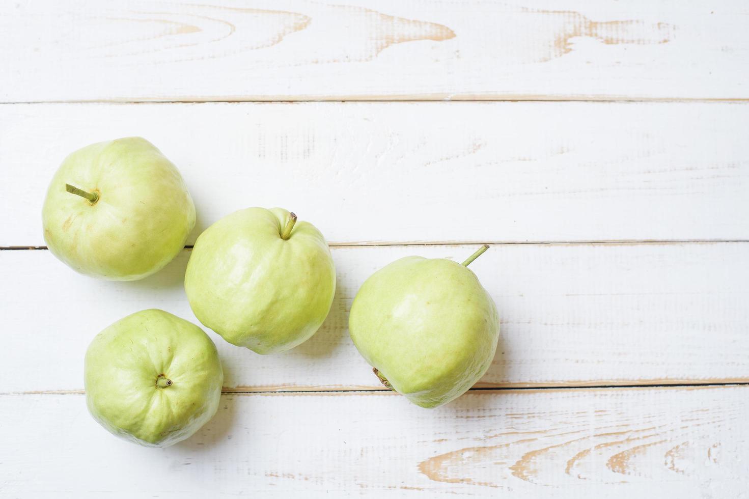 Guavas on white wooden table. photo