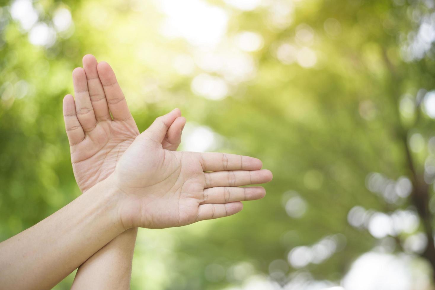 World peace Day , human hand on green background photo