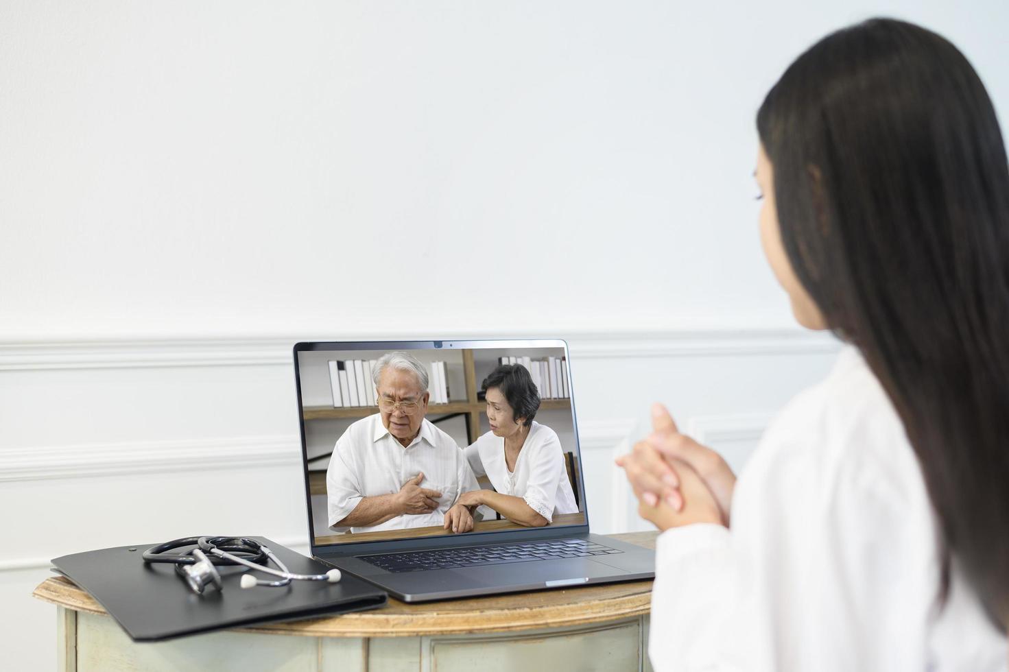 Female doctor making video call on social network with patient consulting about health problems. photo