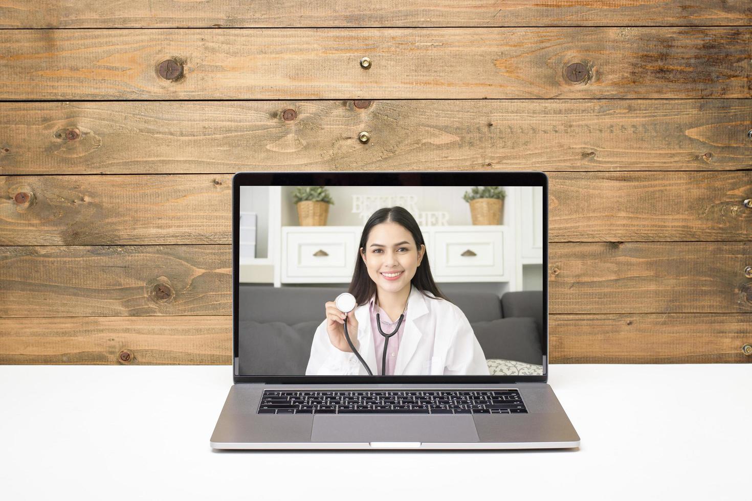 Female doctor making video call on social network with patient consulting about health problems. photo