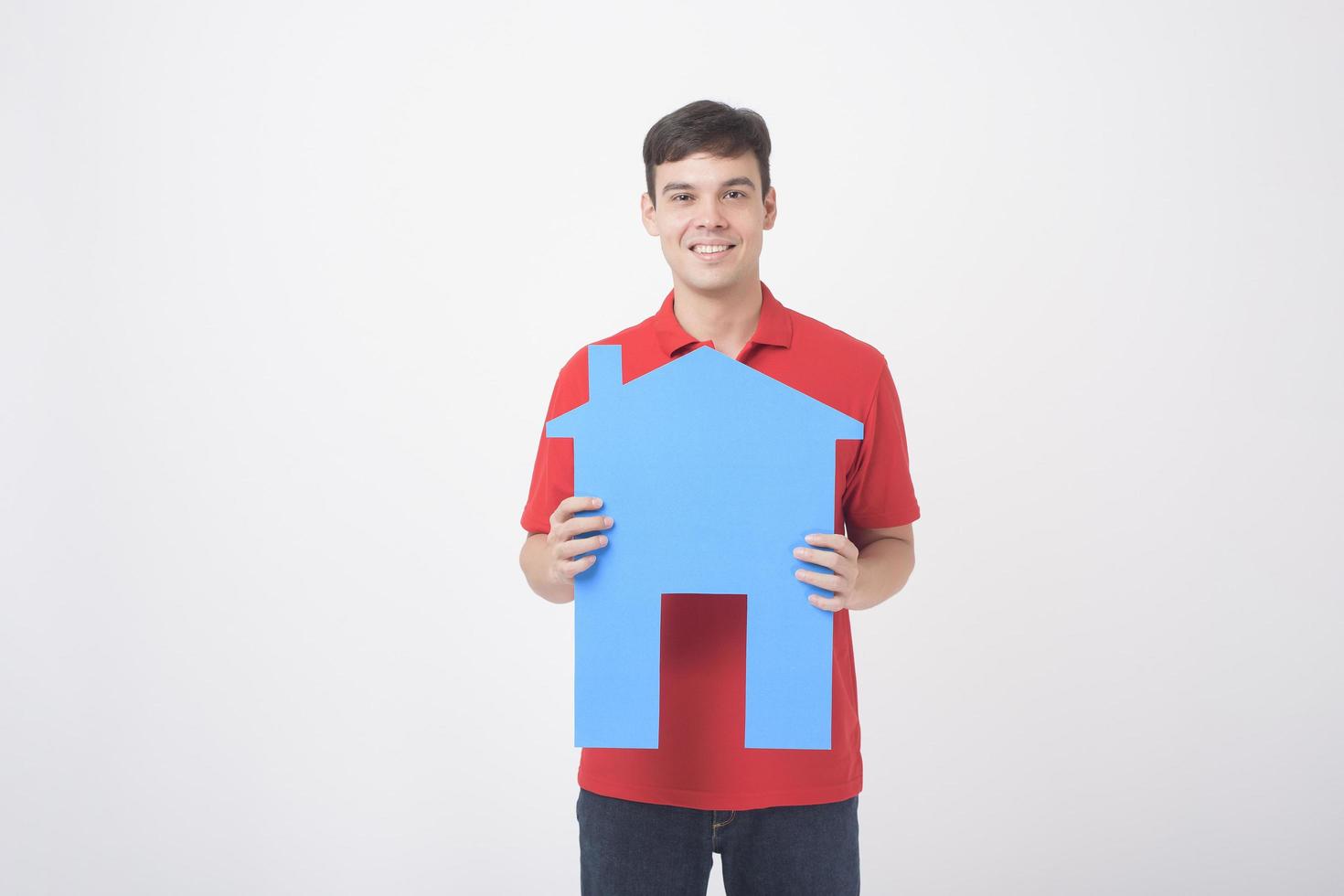 Portrait of handsome man is holding paper home on white background photo