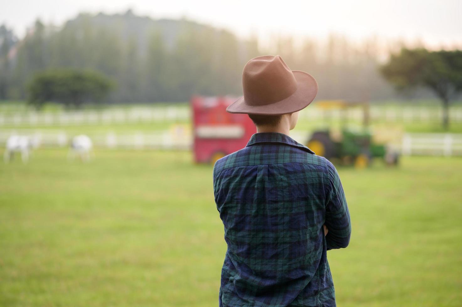 A young man farmer working on Beautiful landscape of country field at dawn photo