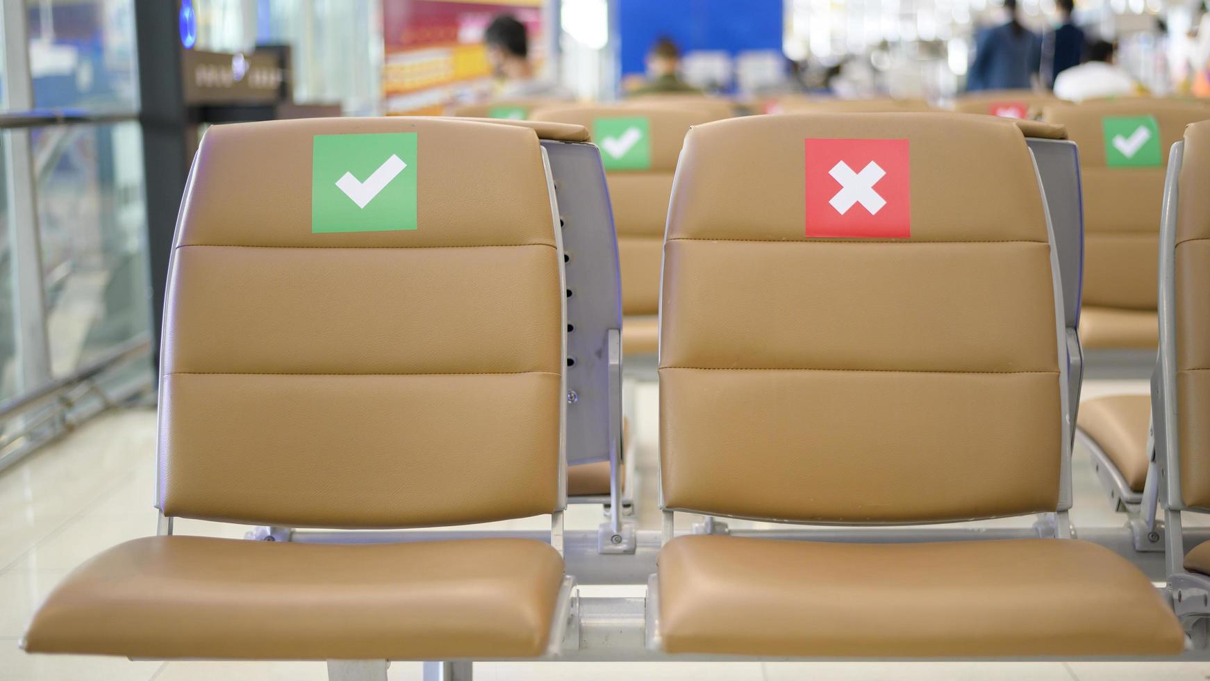 Social distancing chairs in International Airport, Coronavirus prevention concept photo