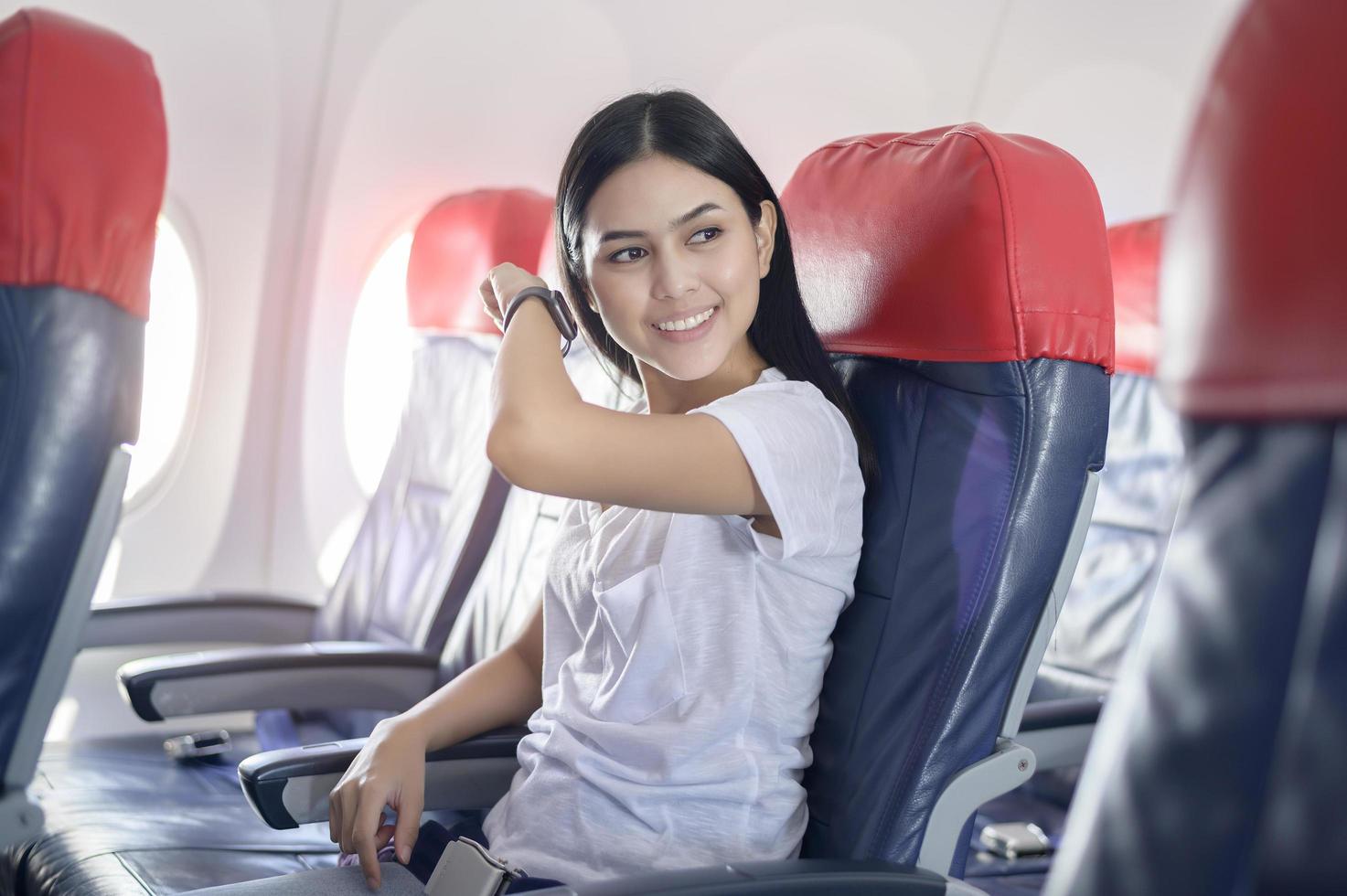 Traveling woman using onboard, technology travel concept photo