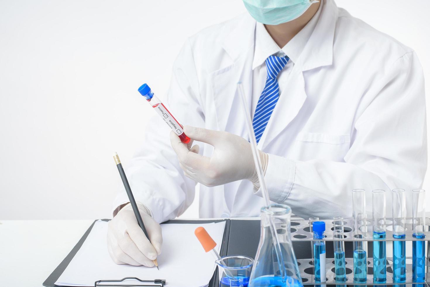 laboratory assistant hand is holding blood test infected Covid-19 photo