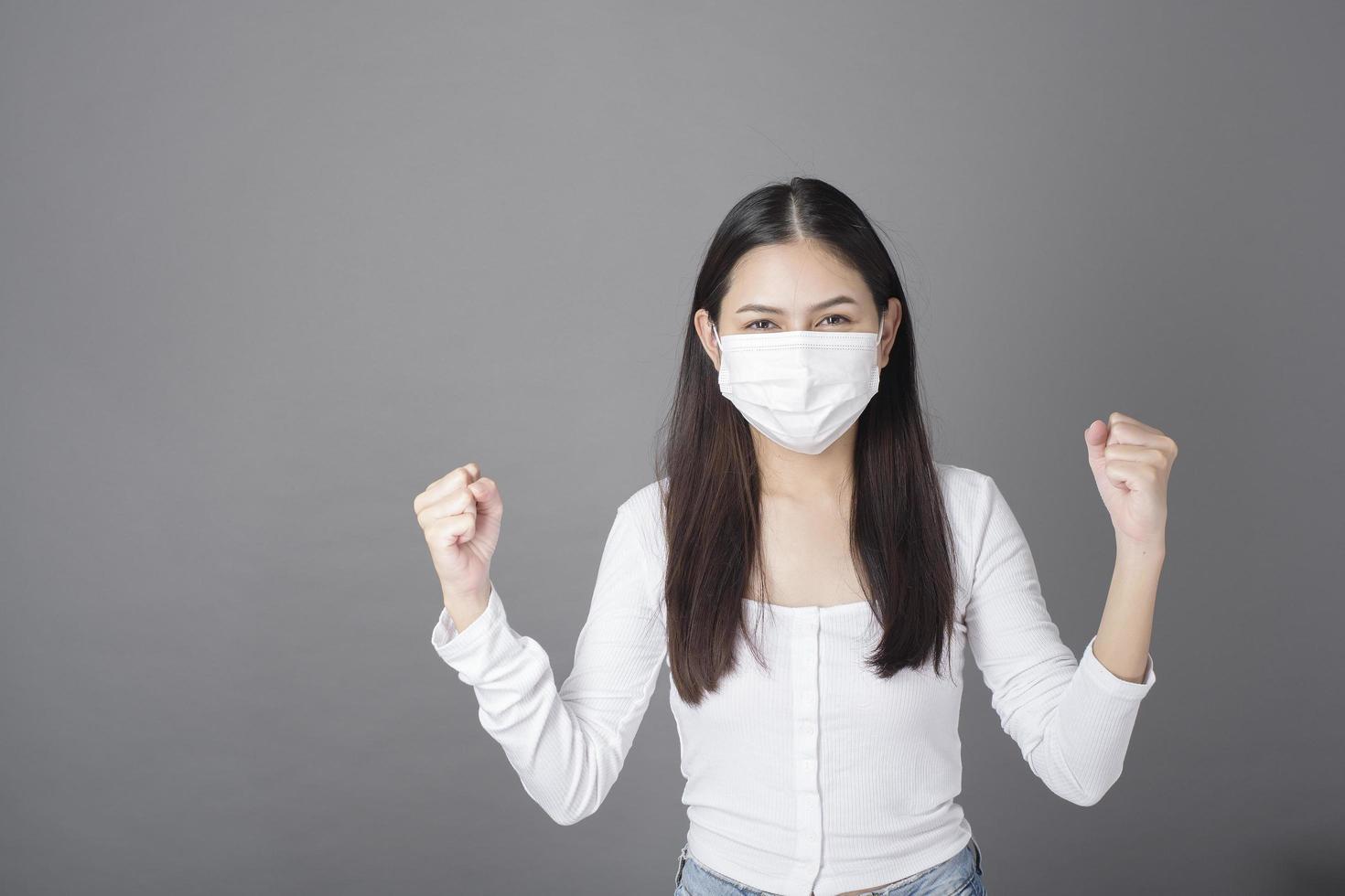 Portrait of woman with surgical mask  in studio, Health care concept photo