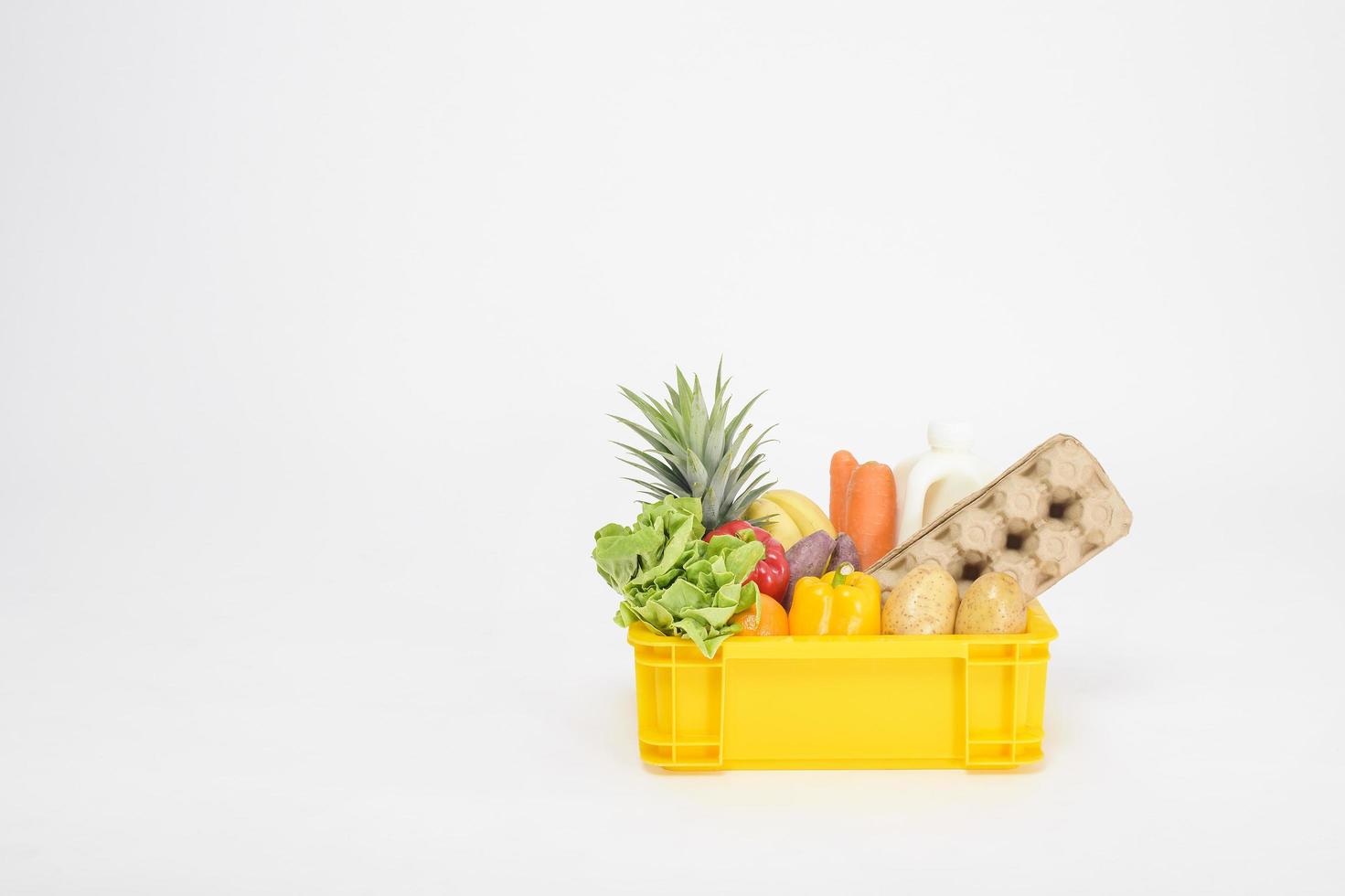 Set of delivery raw food in plastic box on white  background photo