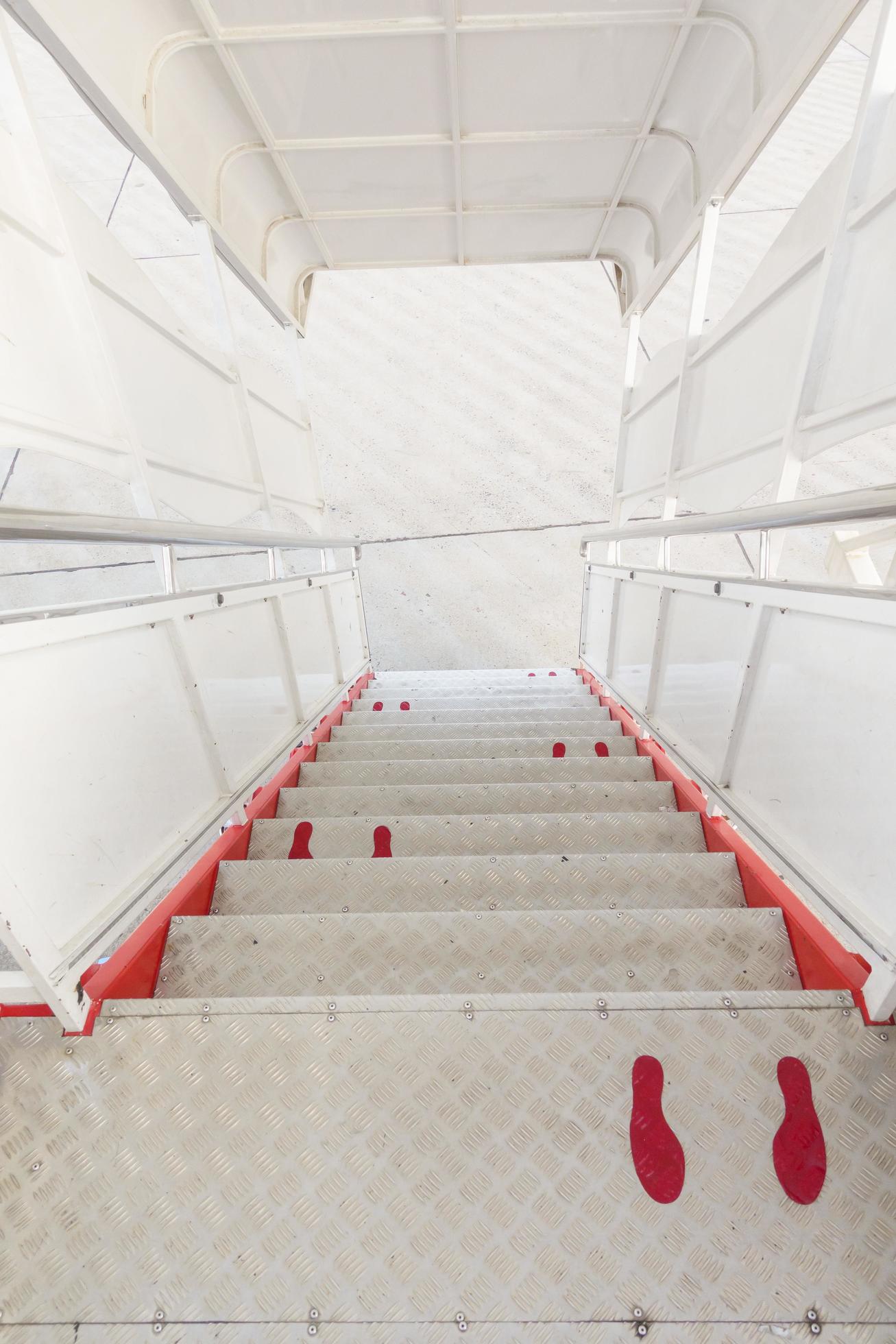 foot sign on airplane corridor, Social distancing protocol on aviation