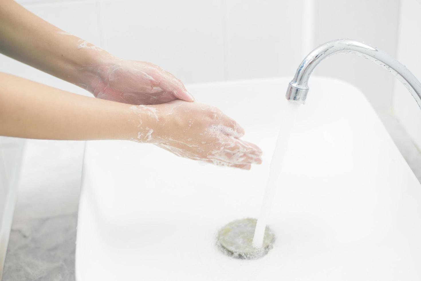 A woman is washing hands photo