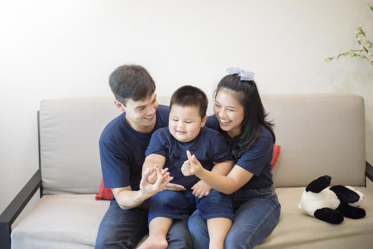 Happy family are enjoying on sofa at home, Safety home activity concept photo