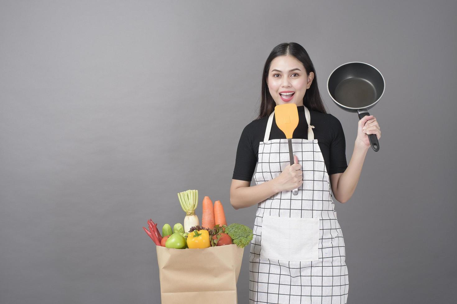 Happy woman is preparing healthy food to cooking photo