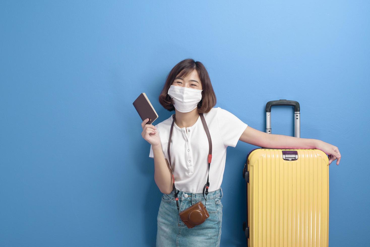 portrait of young traveler woman with face mask , New normal travel concept photo