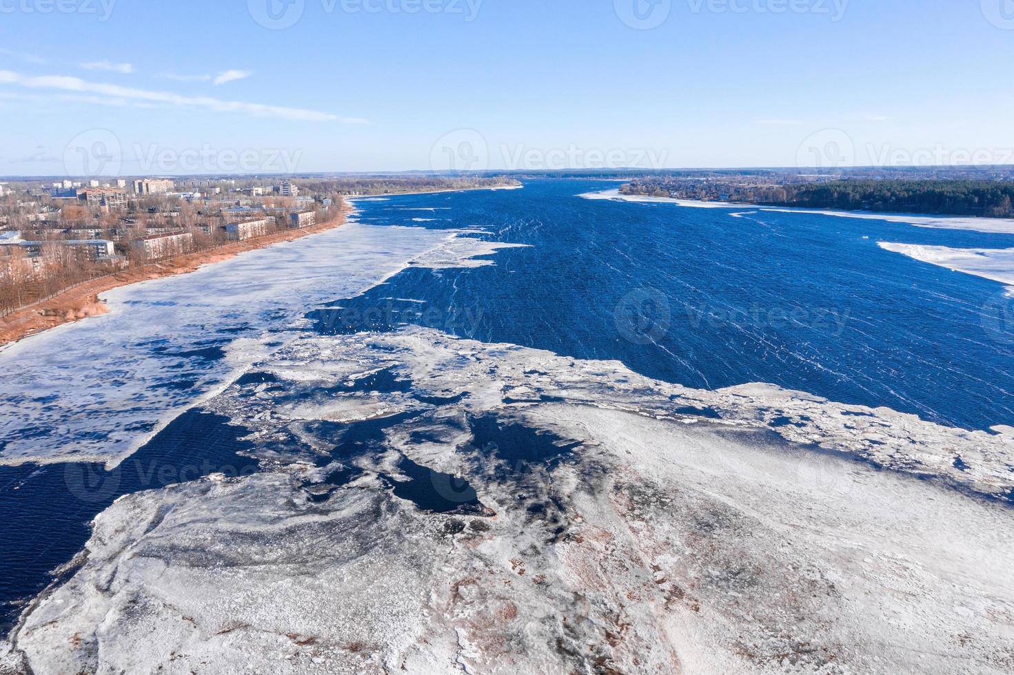 Aerial view of the South bridge over river Daugava in Latvia with an ice formed patterns floating in the river. photo