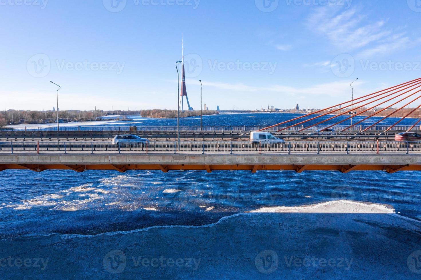 Aerial view of the South bridge over river Daugava in Latvia with an ice formed patterns floating in the river. photo