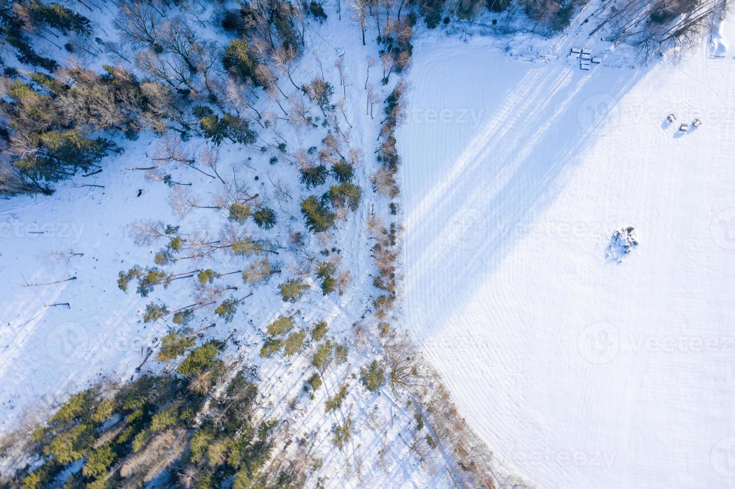 Fabulous aerial winter panorama of mountain forest with snow covered fir trees. Colorful outdoor scene, Happy New Year celebration concept. Beauty of nature concept background. photo