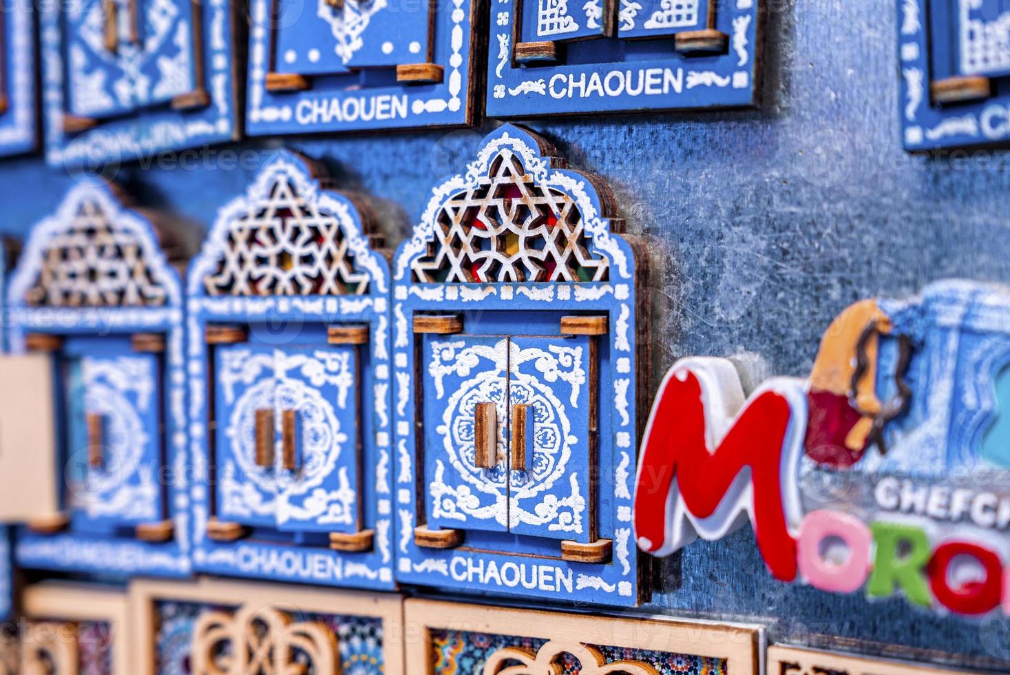 Carved wooden door magnets for sale at moroccan marketplace photo