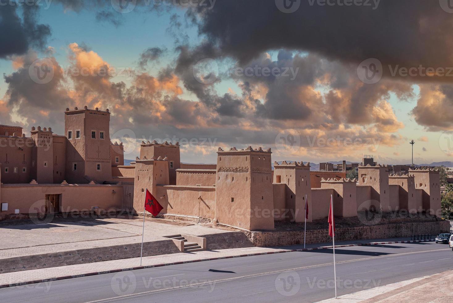 Ancient fort building with national flag on sides of road photo