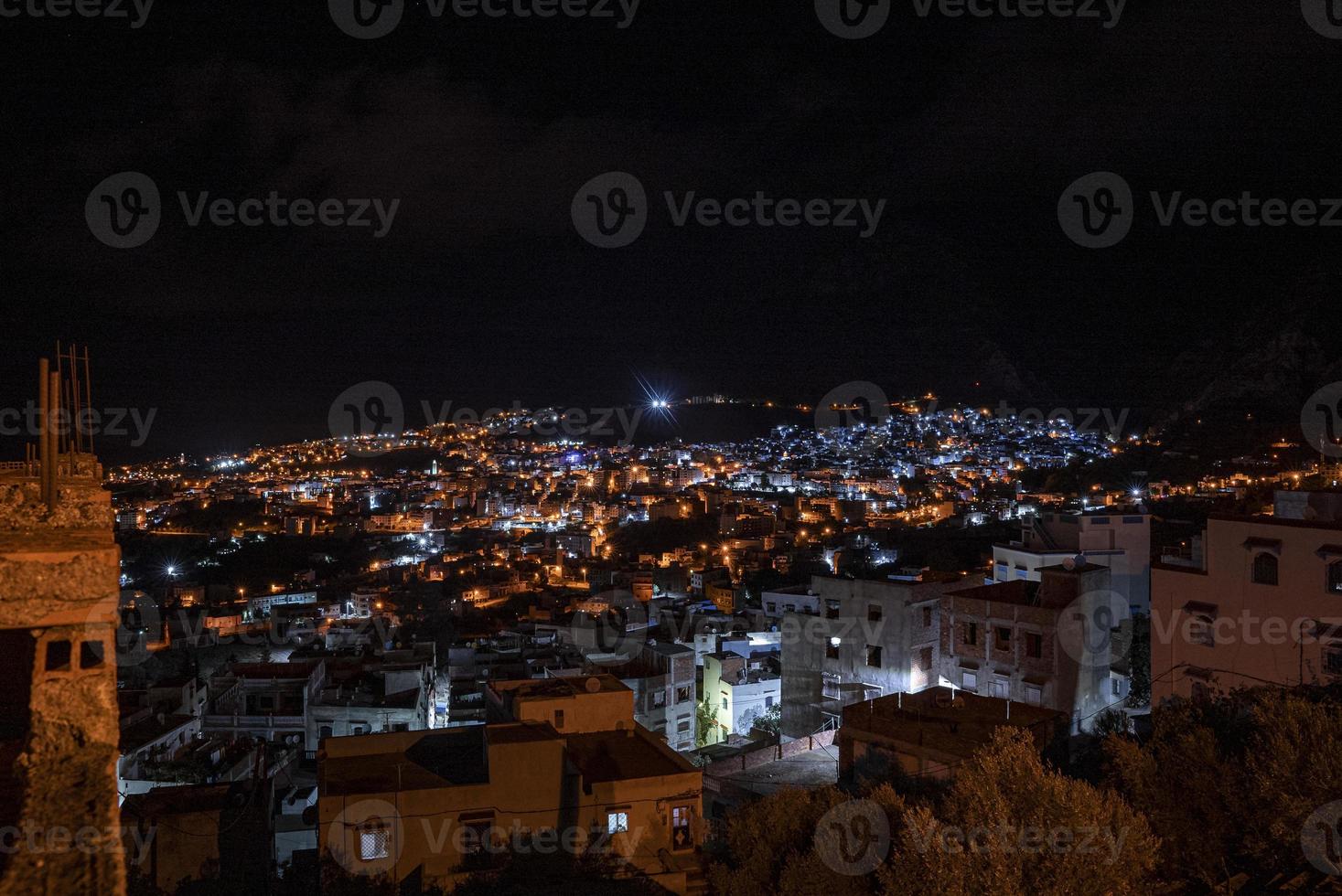 Aerial view of illuminated residential structures in dark at night photo