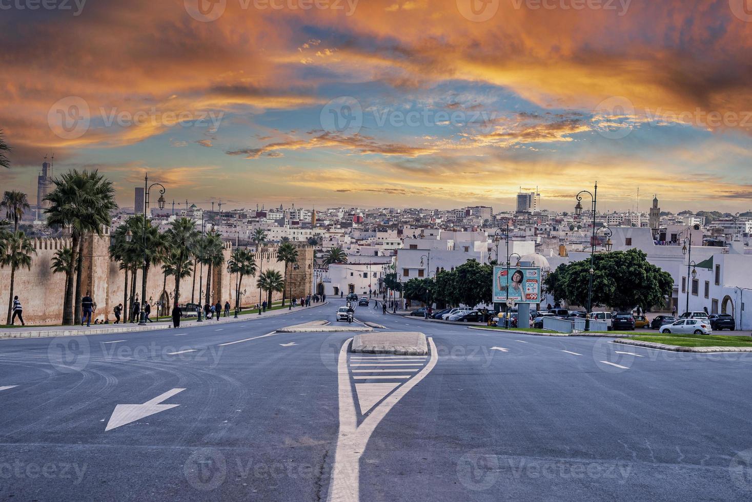 View of walls of Kasbah of the Udayas and cityscape against cloudy sky photo