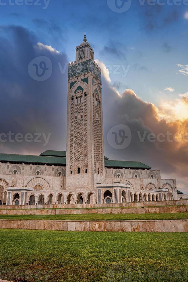 Low angle view of historic Mosque Hasan II with tallest minaret against dramatic sky photo