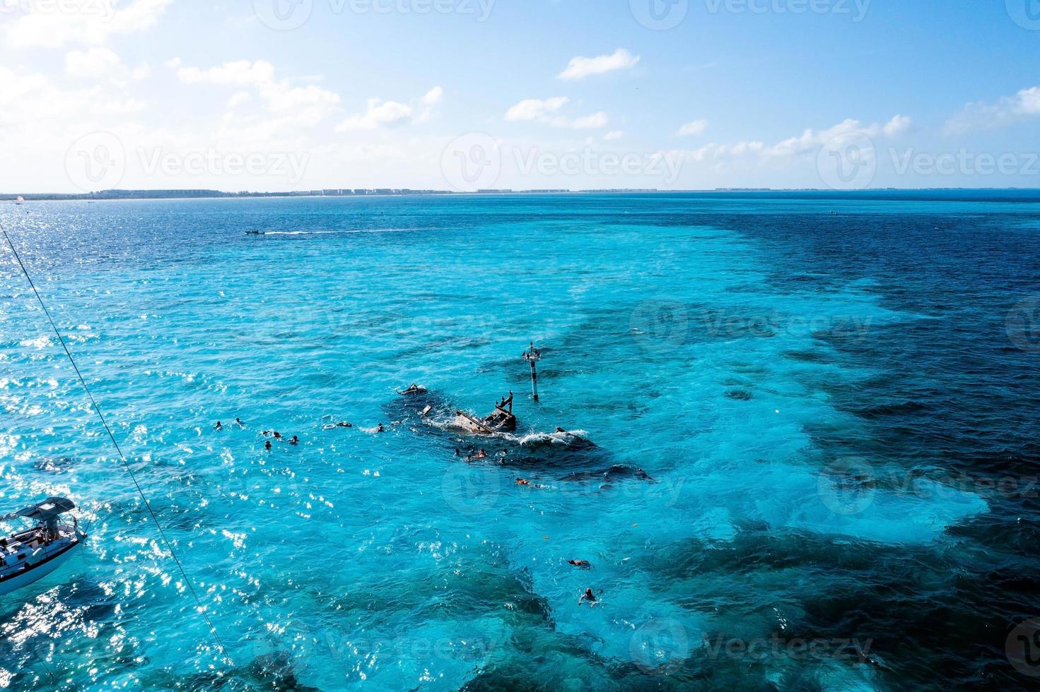 People snorkelling around the ship wreck near Bahamas in the Caribbean sea. photo