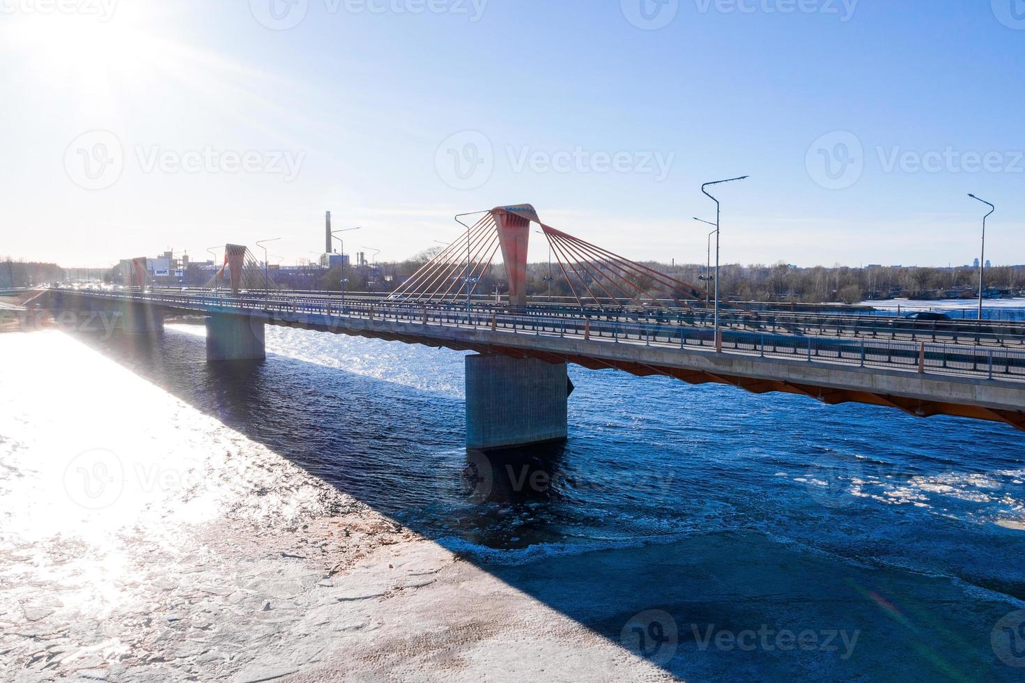 Aerial view of the South bridge over river Daugava in Latvia with an ice formed patterns floating in the river. photo