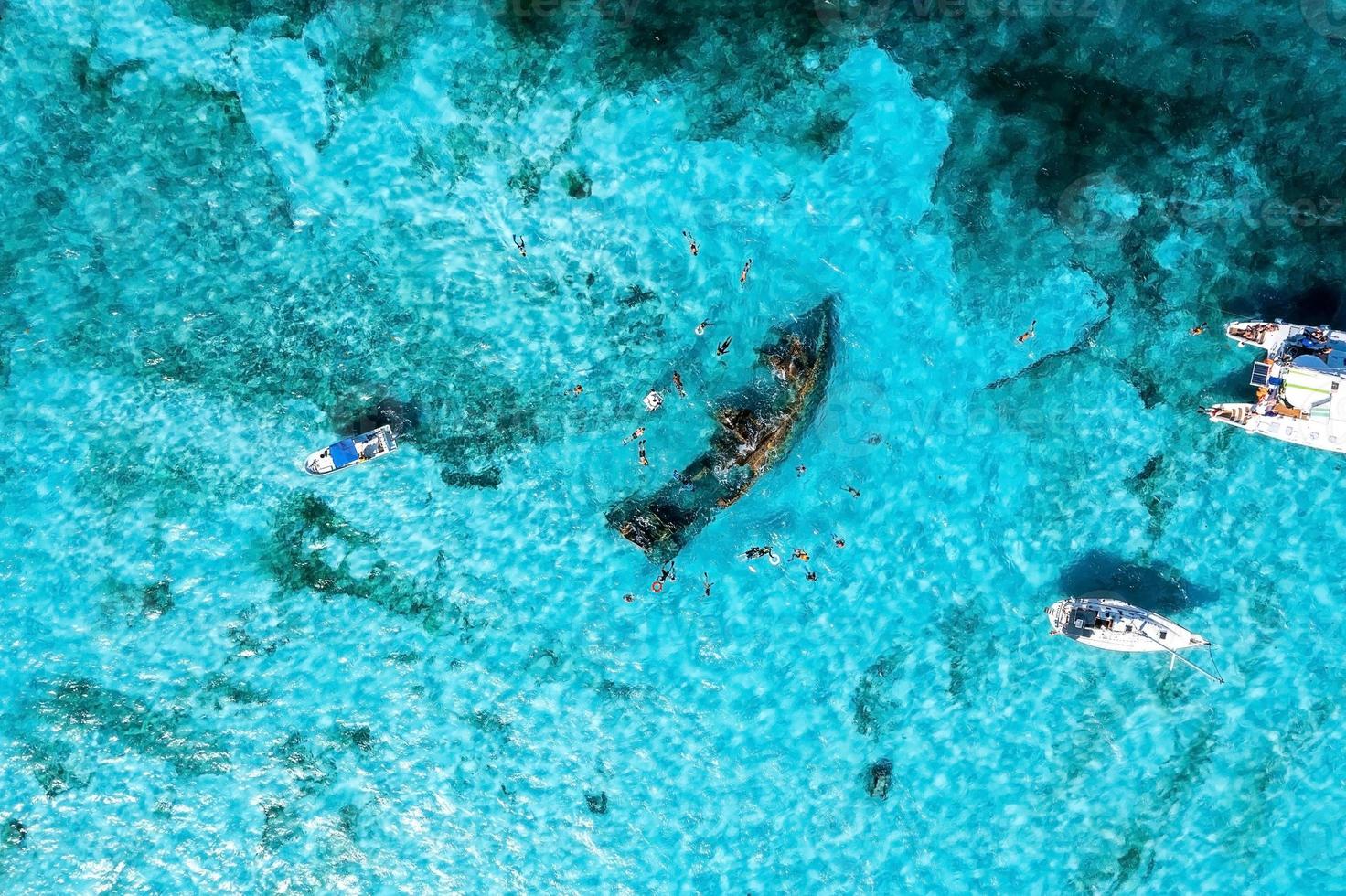 People snorkelling around the ship wreck near Cancun in the Caribbean sea. photo