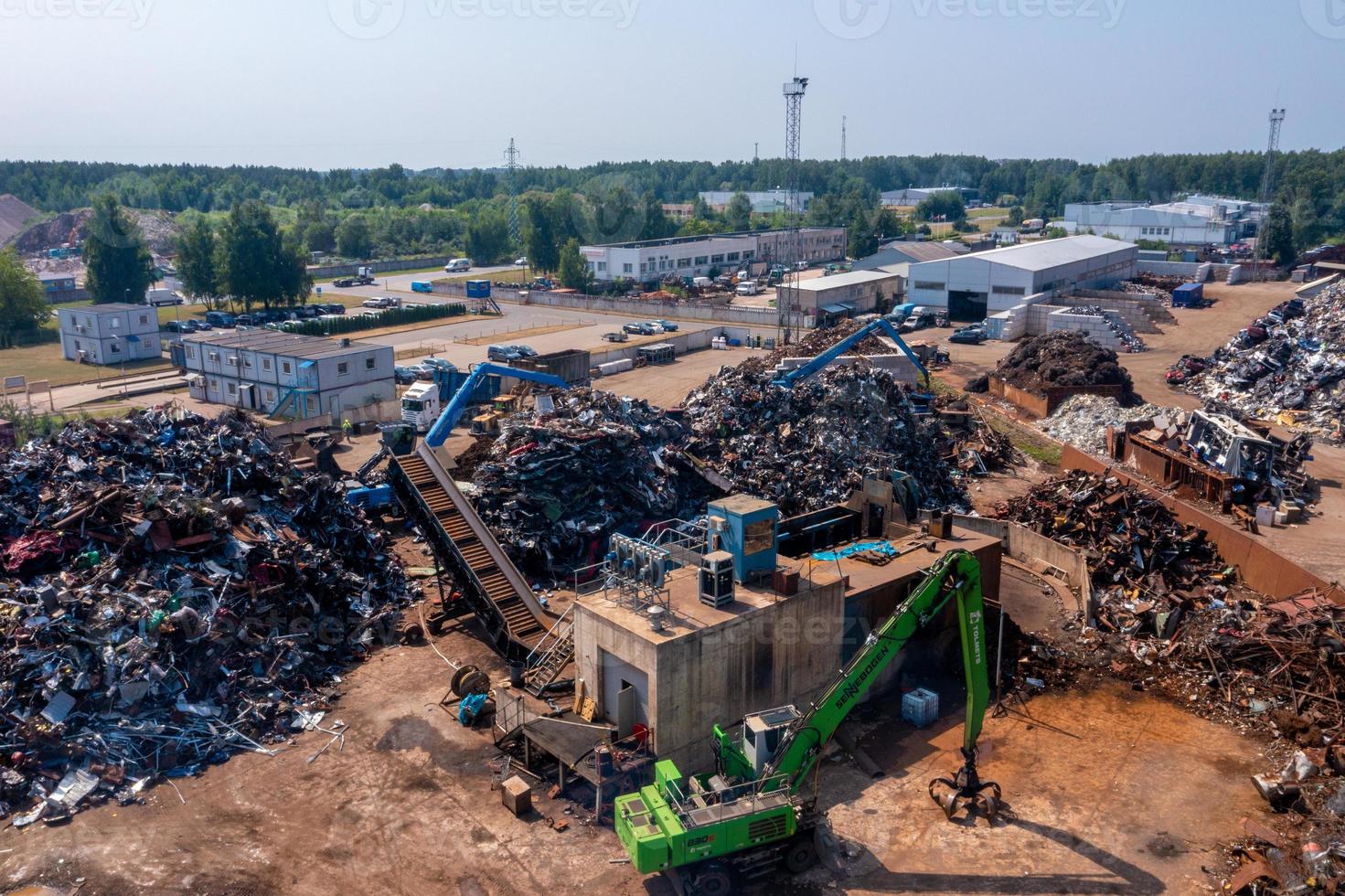 Old damaged cars on the junkyard waiting for recycling photo