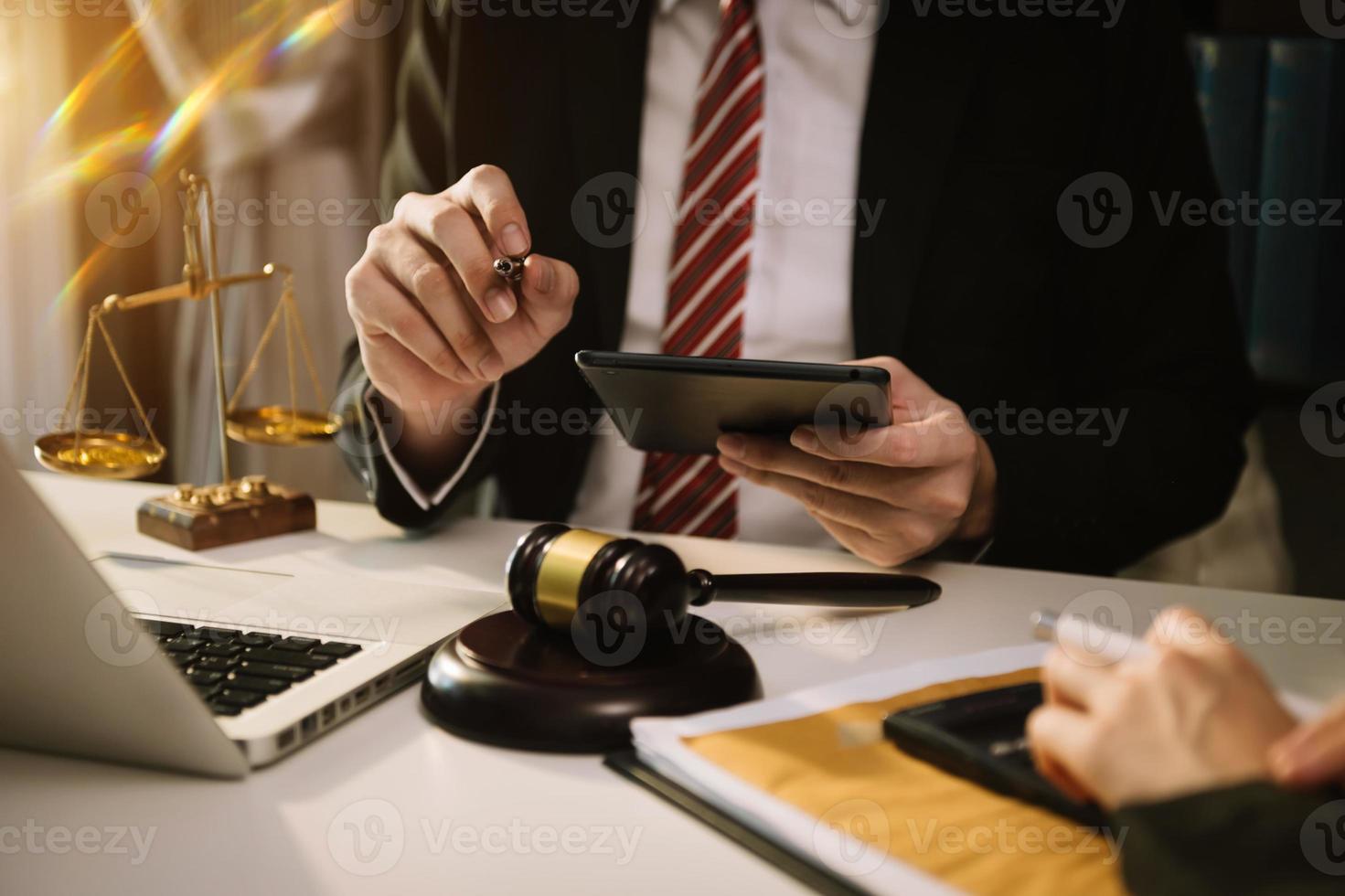 Business and lawyers discussing contract papers with brass scale on desk in office. Law, legal services, advice,  justice and law concept . photo