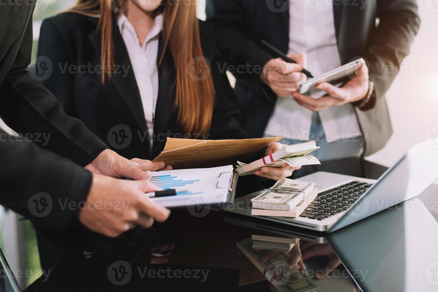 Business documents on office table with smart phone and calculator digital tablet and graph business with social network diagram and two colleagues discussing data working in the office photo