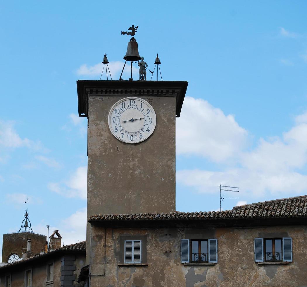 Medieval Torre del Moro, clock tower, in Orvieto. Italy. In 1347 a clock was assigned to regulate the workers involved in the construction of the Cathedral of Orvieto. photo