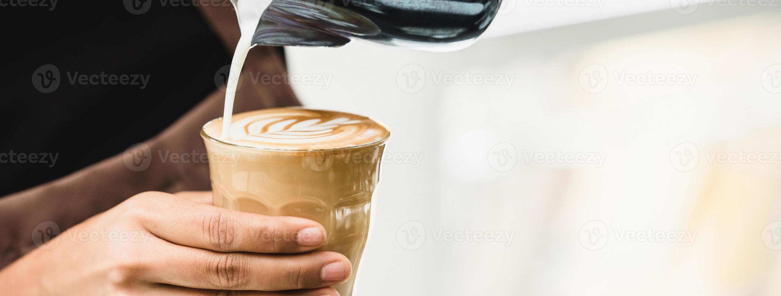 Professional barista making latte art coffee photo