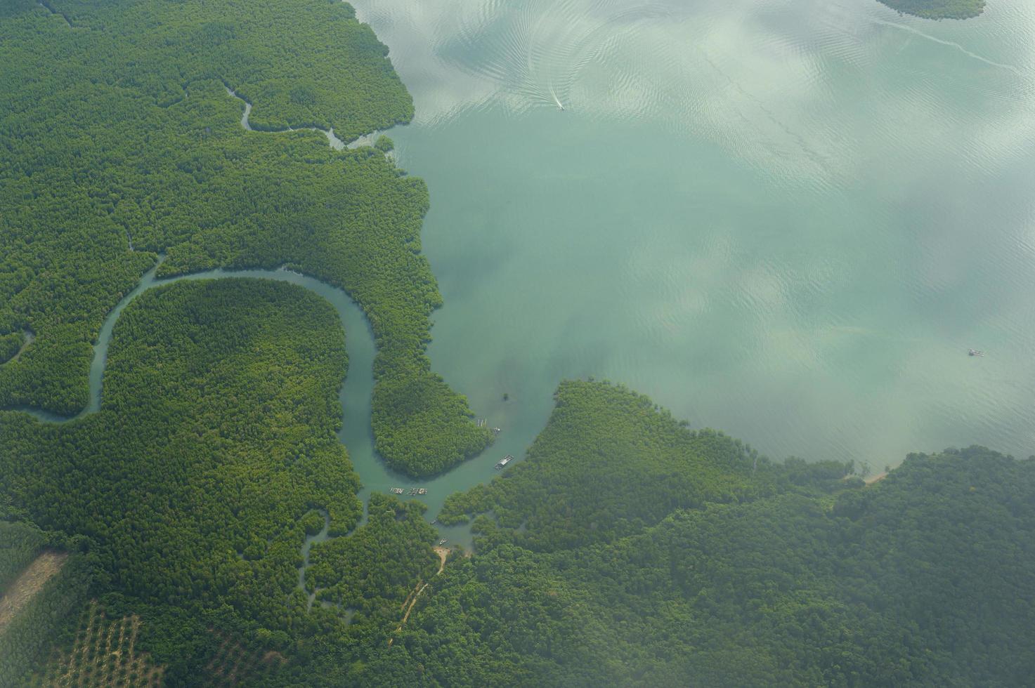 Aerial view photo from airplane of tropical island and turquoise clear ocean.