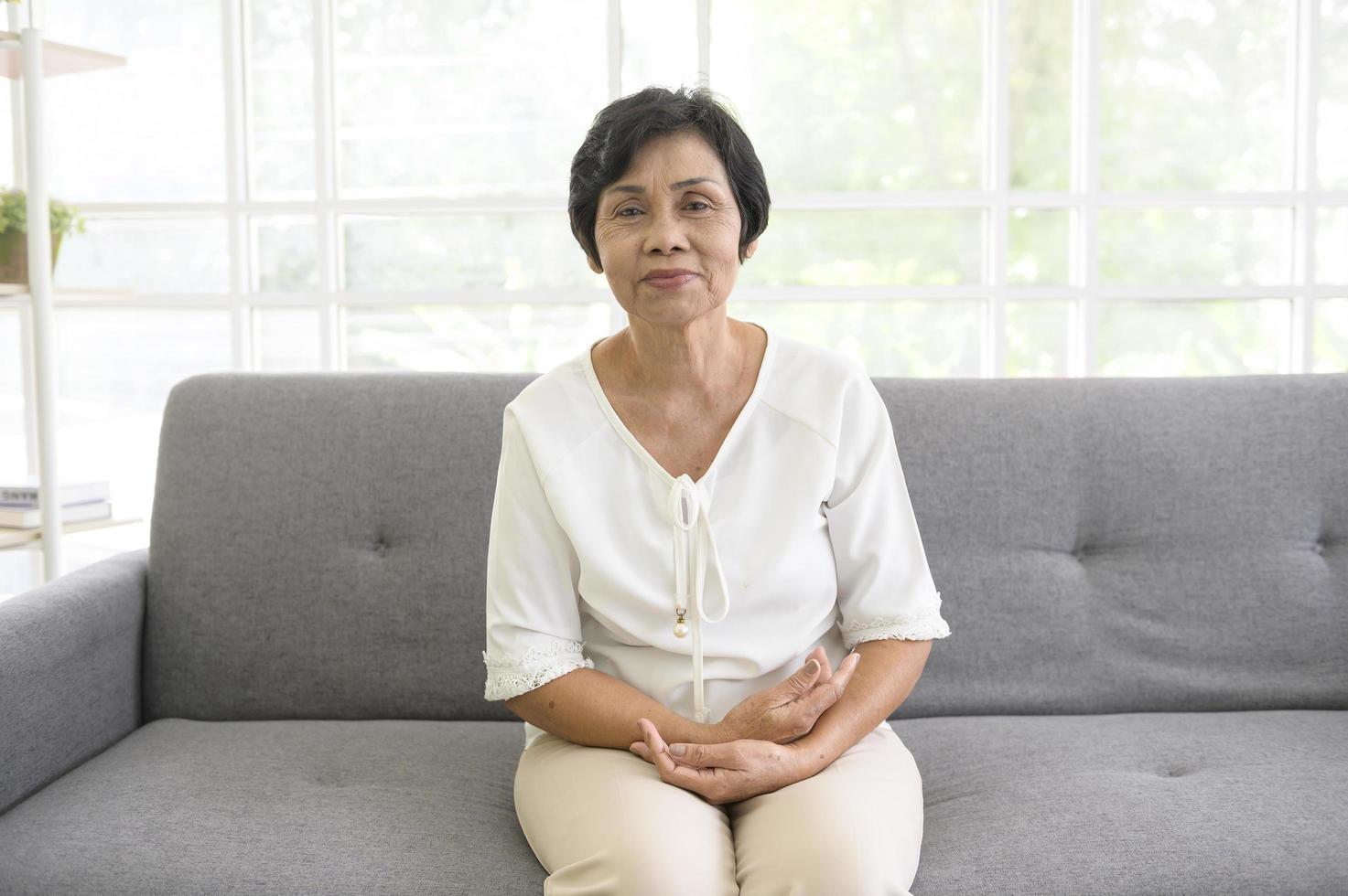 Senior Asian woman making video call on social network with doctor consulting about health problems, head shot close up portrait. photo