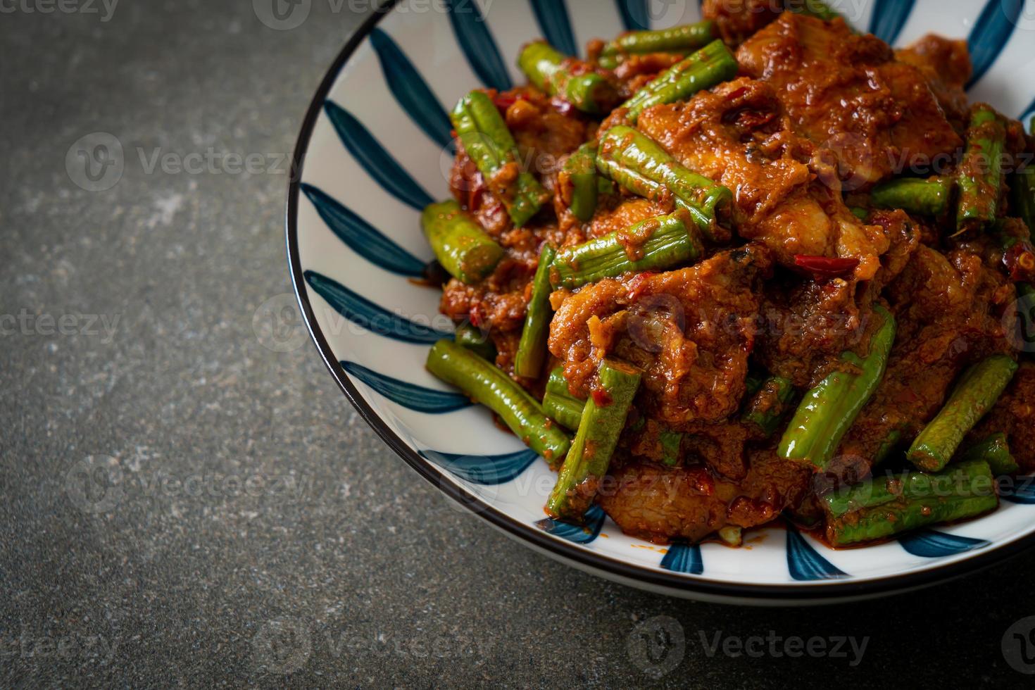 Stir fried pork with red curry paste photo